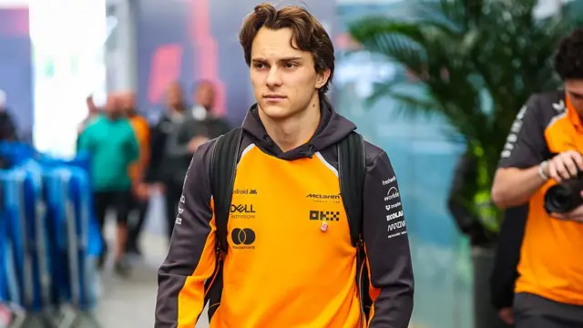 Oscar Piastri walks into the paddock at Interlagos