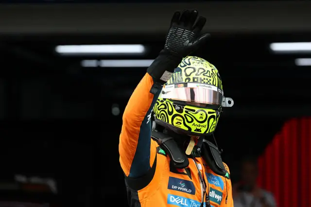 Lando Norris waves to the crowd in Brazil