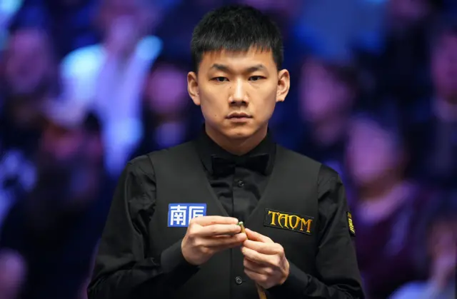 Long Zehuang in action against Zhao Xintong, on day three