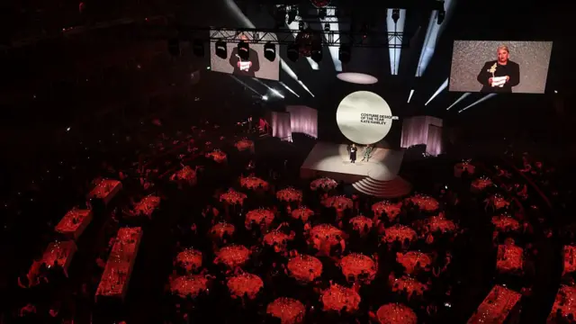 An overhead view of the floor at the Royal Albert Hall with tables and the stage visible