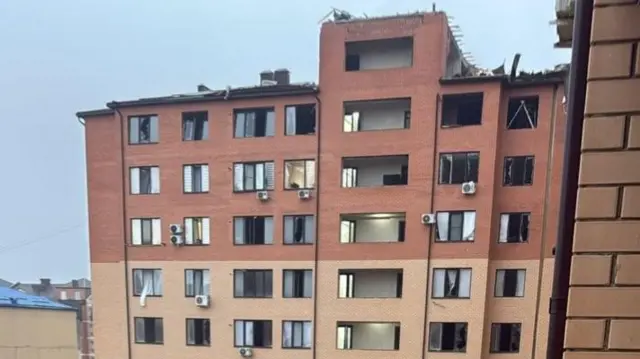 This screengrab shows some of the shattered windows at a brick apartment block following the earlier drone attackl