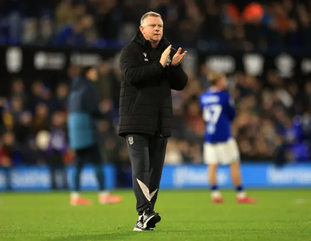 Stoke boss Mark Robins applauds the travelling fans after the 1-0 loss to Ipswich