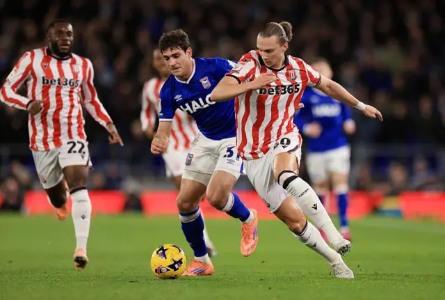 Maksym Talovierov of Stoke City is put under pressure by Ivan Azon of Ipswich Town