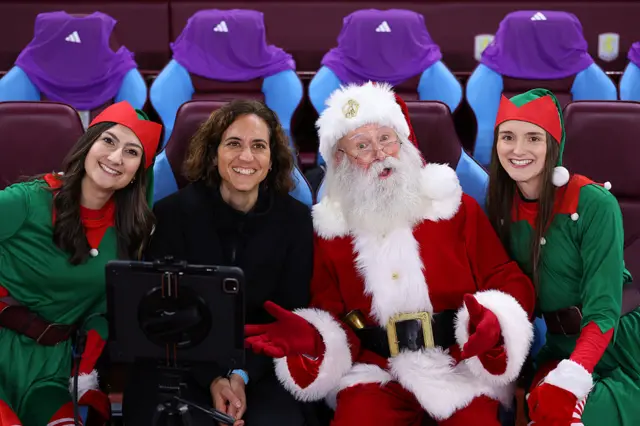 Natalia Arroyo, Manager of Aston Villa, poses for a photo with a people dressed as Elves and Santa Claus prior to the Barclays Women's Super League match between Aston Villa and Liverpool at Villa Park on December 11, 2025 in Birmingham, England.