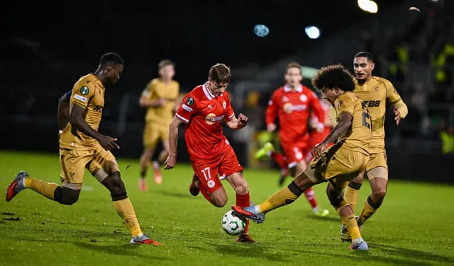 Daniel Kelly of Shelbourne in action against Marc Guéhi, left, and Chris Richards of Crystal Palace during the UEFA Conference League 2025/26 league phase match between Shelbourne and Crystal Palace at Tallaght Stadium in Dublin.