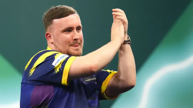 Luke Littler applauds