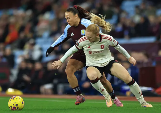 Ceri Holland of Liverpool is challenged by Ebony Salmon of Aston Villa
