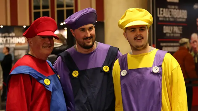 Darts fans dresses as Mario characters