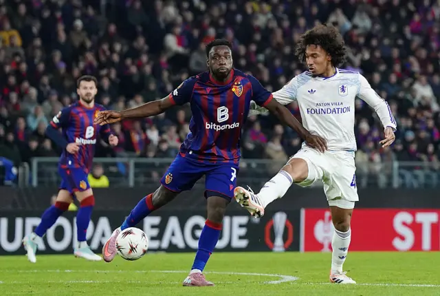 Philip Otele of FC Basel 1893 is challenged by Boubacar Kamara of Aston Villa during the UEFA Europa League 2025/26 League Phase MD6 match between FC Basel 1893 and Aston Villa FC at St. Jakob-Park on December 11, 2025 in Basel, Switzerland.