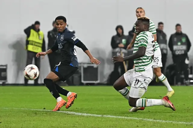 Jayden Meghoma (L) and Ferencvaros' Nigerian forward Bamidele Yusuf vie for the ball