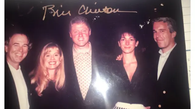 two unknown individuals stand smiling beside Bill Clinton, Ghislaine Maxwell, and Jeffrey Epstein in an old photo
