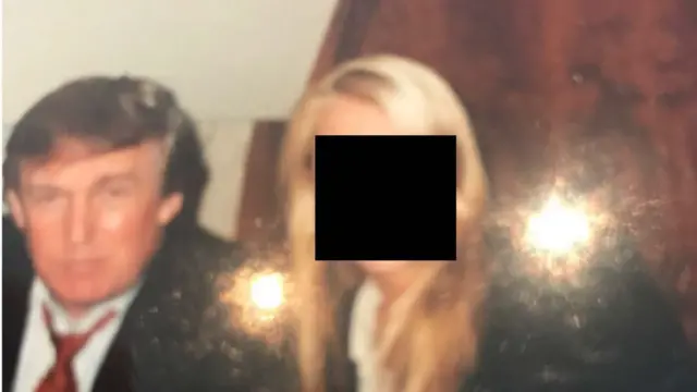 Donald Trump next to a blonde woman with long hair whose face is blanked out.