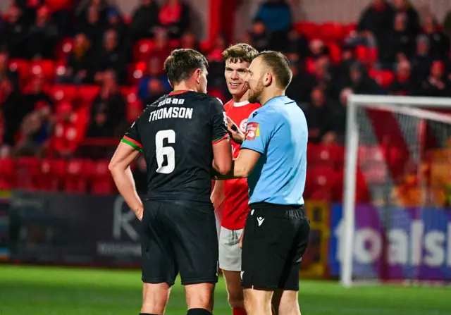 Joe Thomson and Leroy Millar are spoken to by the referee