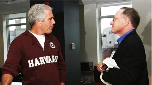 profile of Epstein standing in front of Dershowitz, as the pair appear to be chatting