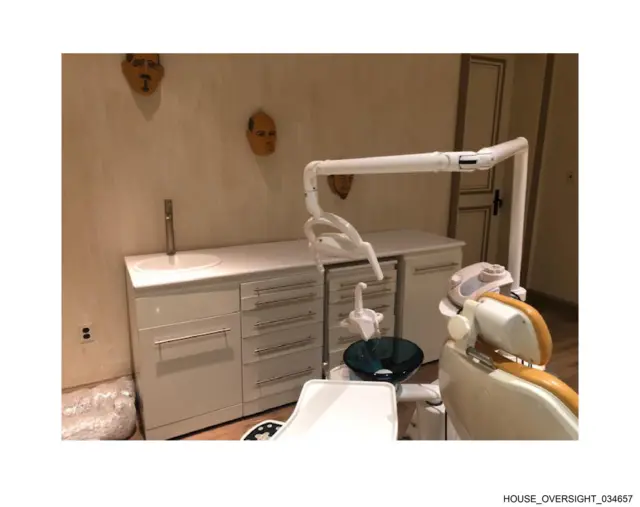 A close up of cabinets and masks on the wall in a room on Epstein's island