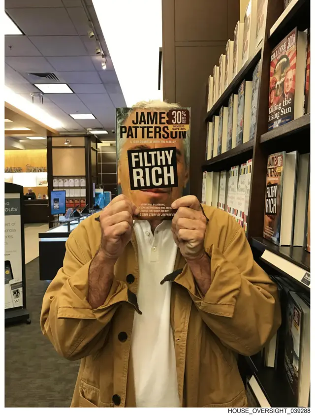 A person holding up a book