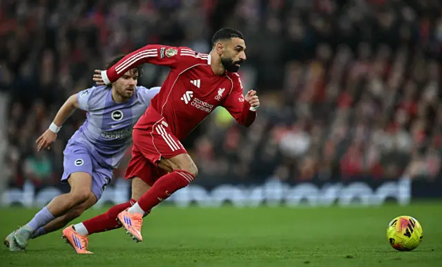 Mohamed Salah outruns a challenge from Brighton's Turkish defender Ferdi Kadioglu
