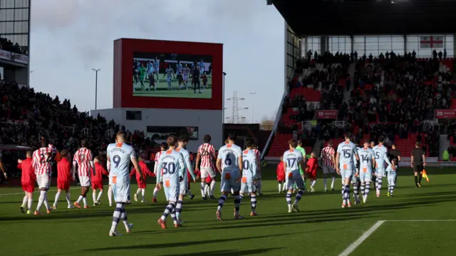 Stoke and Swansea players enter the field