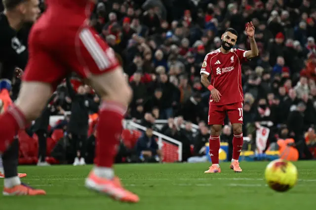 Mohamed Salah waves as he apologies to Liverpool's Dutch defender Virgil van Dijk