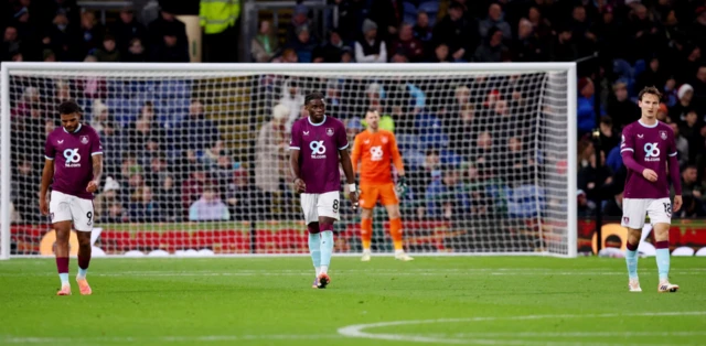 Burnley's Lyle Foster, Lesley Ugochukwu and Hjalmar Ekdal look dejected after Fulham's Calvin Bassey scores their second goal