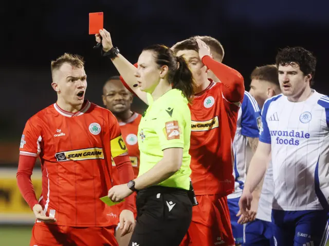 Louise THompson shows a red card