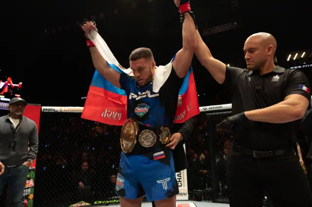 Vadim Nemkov has his arm raised with the belt around his waist