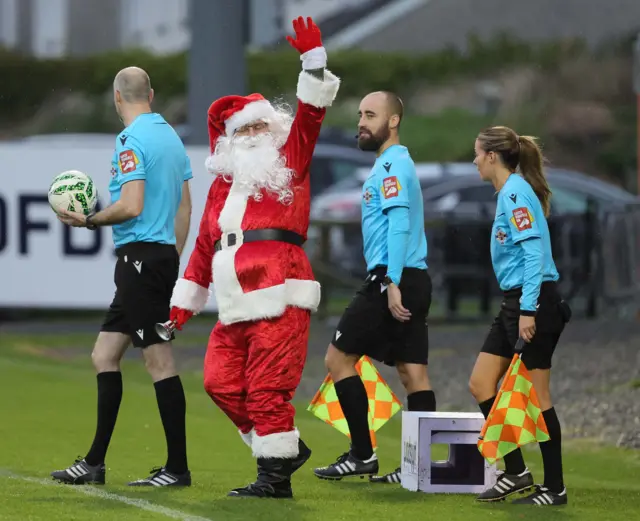 Santa walks out with match officials