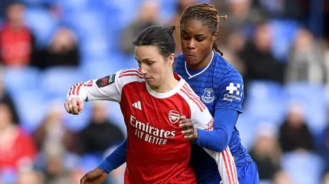 Lotte Wubben-Moy of Arsenal controls the ball whilst under pressure from Kelly Gago of Everton during the Barclays Women's Super League match between Everton and Arsenal at Goodison Park on December 13, 2025 in Liverpool, England.