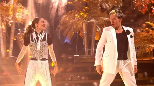 Karen and Carlos in matching black and white suits