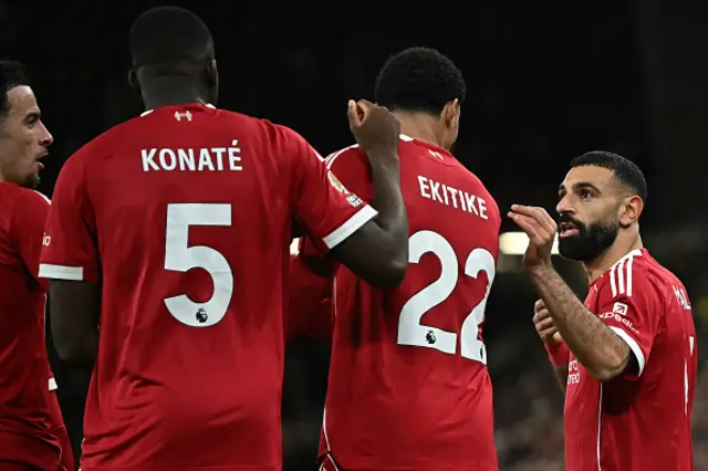 Mohamed Salah (R) talks to Liverpool's French striker Hugo Ekitike (2R) after Ekitike scored