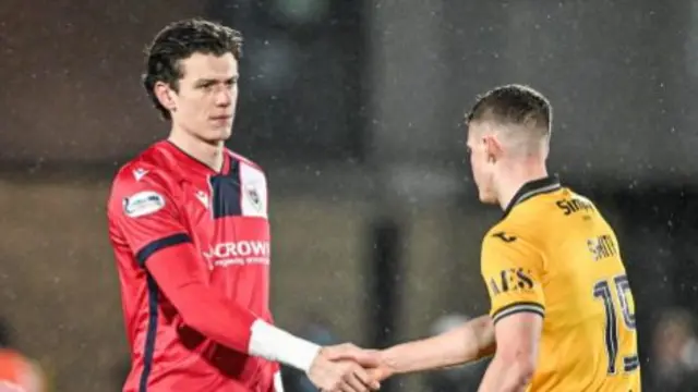 Dundee goalkeeper Jon McCracken and Livingston player Lewis Smith