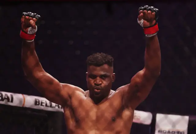 Francis Ngannou with his arms in the air
