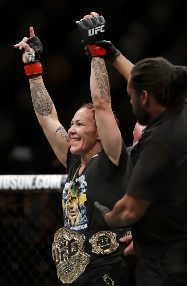 Cris Cyborg with the UFC belt around her waist