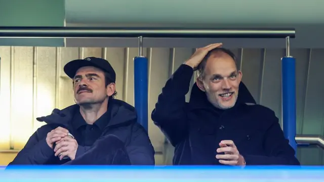 Thomas Tuchel smiling while watching Chelsea versus Everton