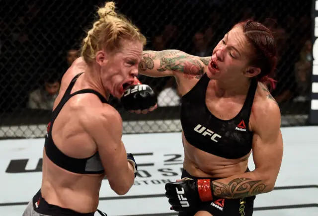 Cris Cyborg punches Holly Holm in the face