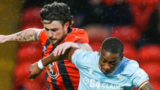 Dundee United's Will Ferry and Motherwell's Tawanda Maswanhise