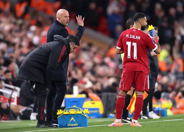 Arne Slot, Manager of Liverpool, talks to Mohamed Salah