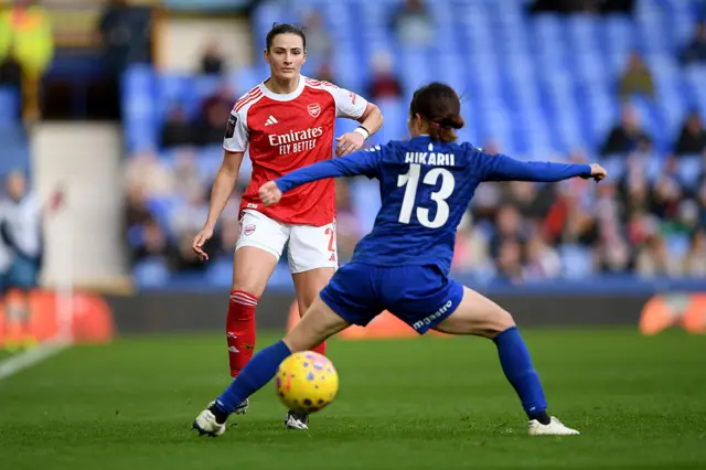 Emily Fox of Arsenal crosses the ball past Hikaru Kitagawa of Everton during the Barclays Women's Super League match between Everton and Arsenal at Goodison Park on December 13, 2025 in Liverpool, England.