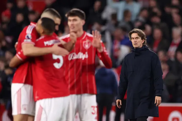 Thomas Frank manager walks past as Nottingham Forest celebrate