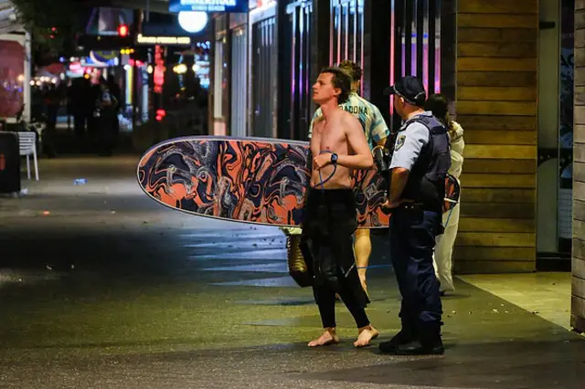 Members of the public look at the scene at Bondi Beach after a mass shooting on December