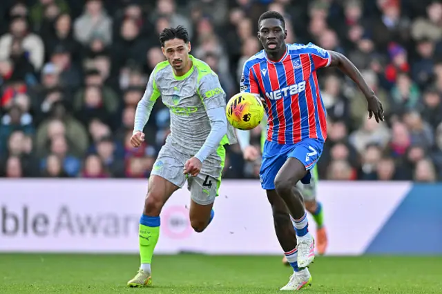 Tijjani Reijnders of Manchester City and Ismaila Sarr of Crystal Palace in action