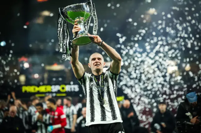 Alex Gogic with the League Cup