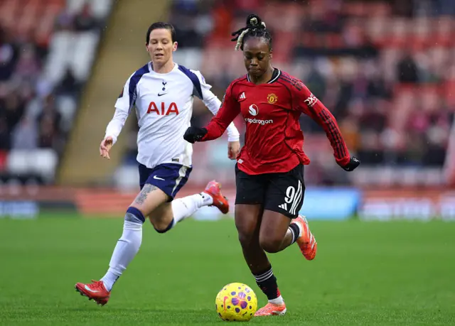 Melvine Malard of Manchester United runs with the ball