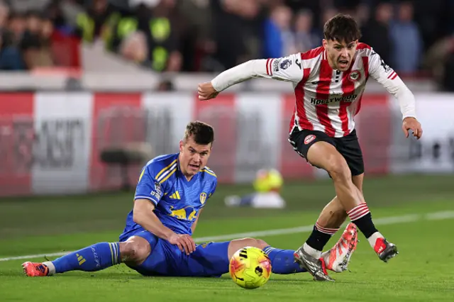 Aaron Hickey of Brentford runs with the ball from Jaka Bijol