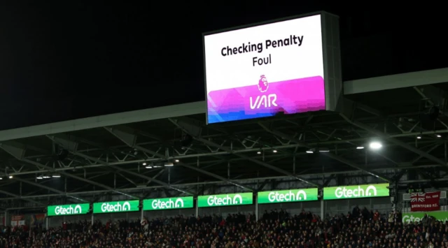 The players wait for a VAR Check for a possible penalty