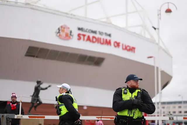 Police officers are seen outside the stadium
