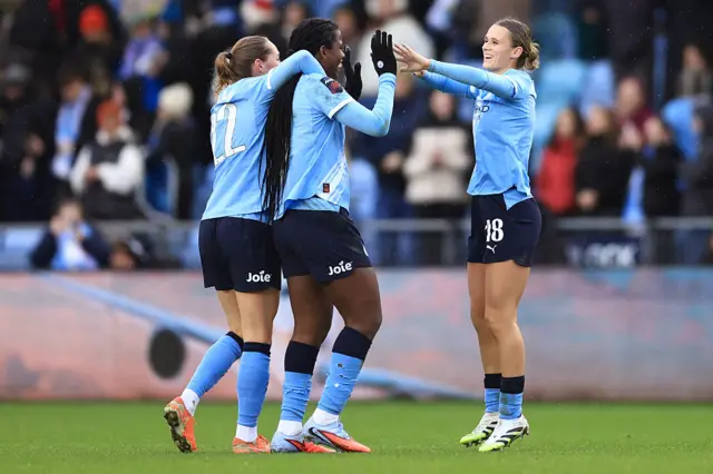 Kerstin Casparij of Manchester City (R) celebrates victory with teammates, Sydney Lohmann (L) and Khadija Shaw (C), after the Barclays Women's Super League match between Manchester City and Aston Villa