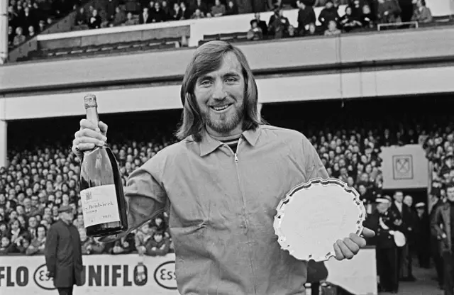 English footballer Billy Bonds of West Ham United FC is awarded the Evening Standard Footballer of the Month trophy and a bottle of Charles Heidsieck champagne