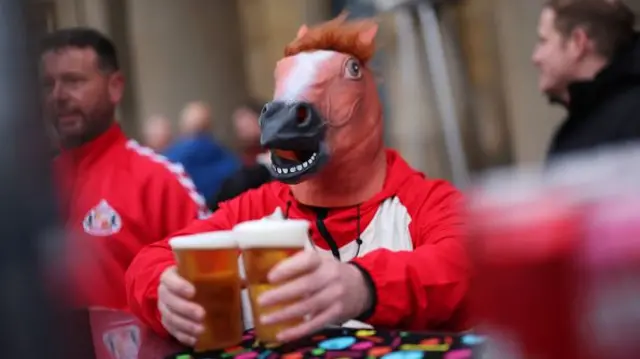 A Sunderland fan wearing a mask disguised as a horse
