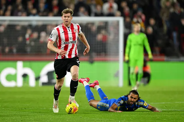 Nathan Collins of Brentford runs with the ball from Dominic Calvert-Lewin